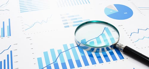 Data Analysis. Charts and tables under magnifying glass