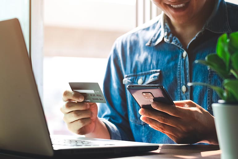 Man using credit card online during onboarding process